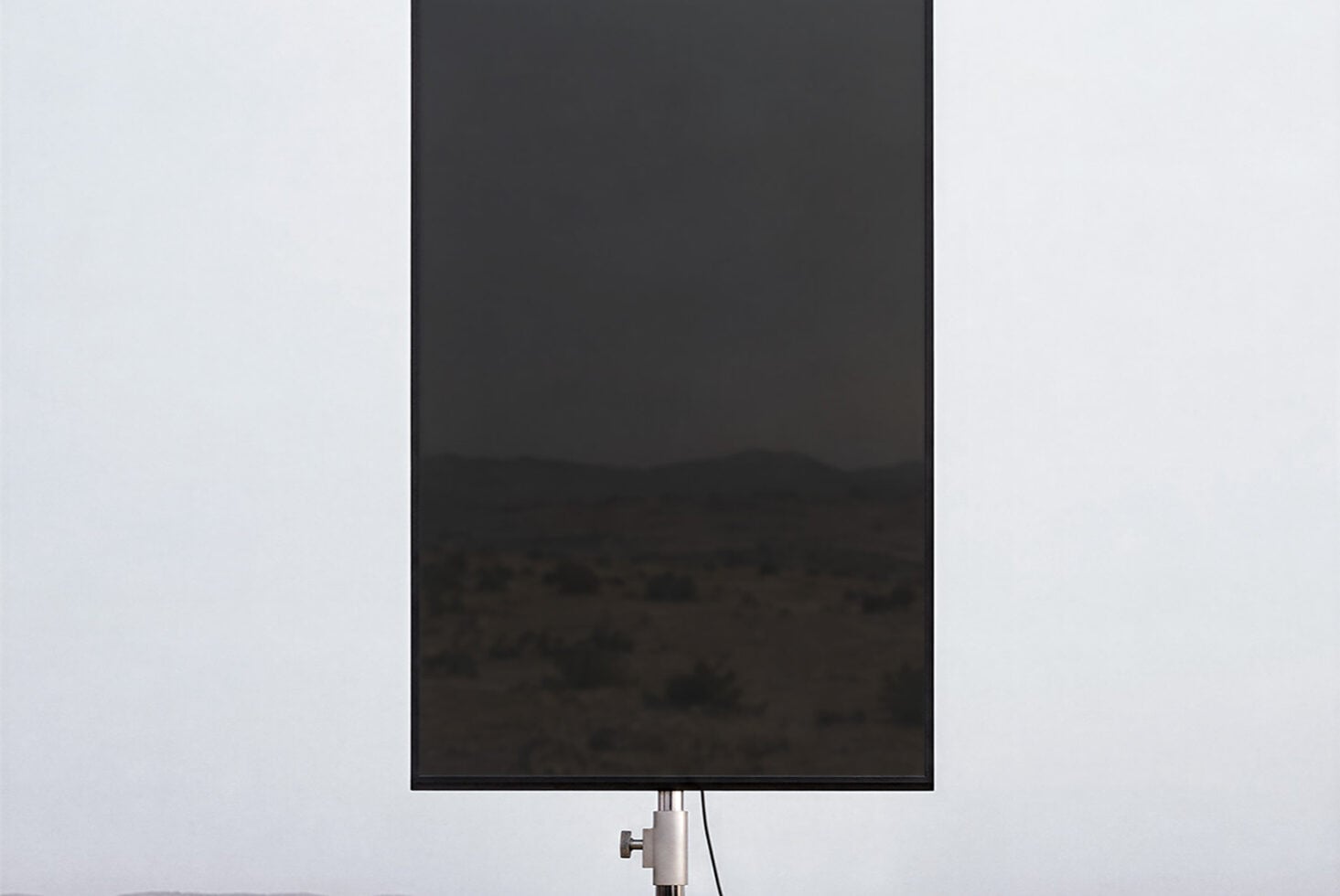 Blank smartphone screen mockup on light background with metal stand