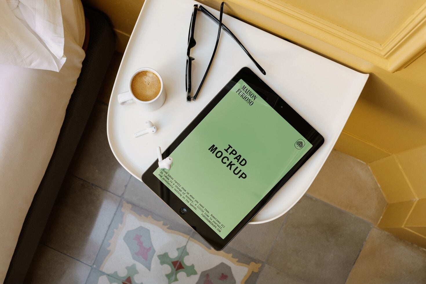 iPad mockup flatlay with coffee, glasses, earbuds on white desk with gold accents