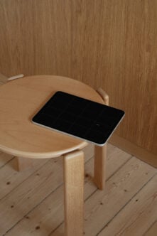 Tablet mockup on wooden round table in minimalist room with wood paneling