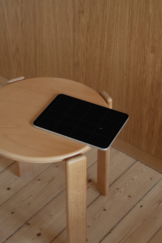 Tablet mockup on wooden round table in minimalist room with wood paneling