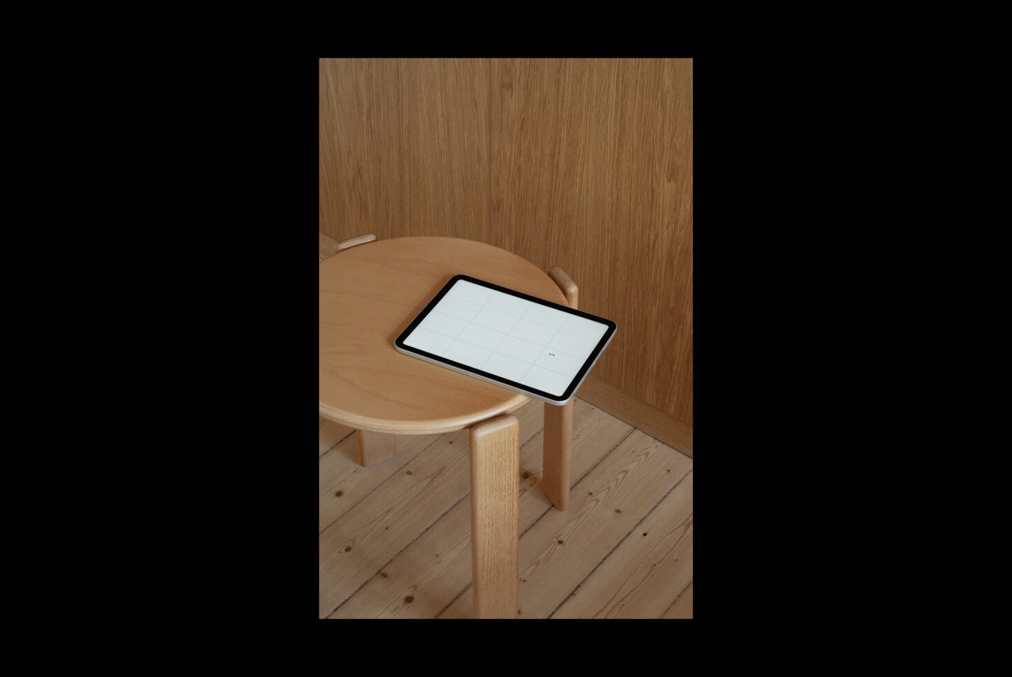 Tablet mockup on wooden round table in minimal wood room interior