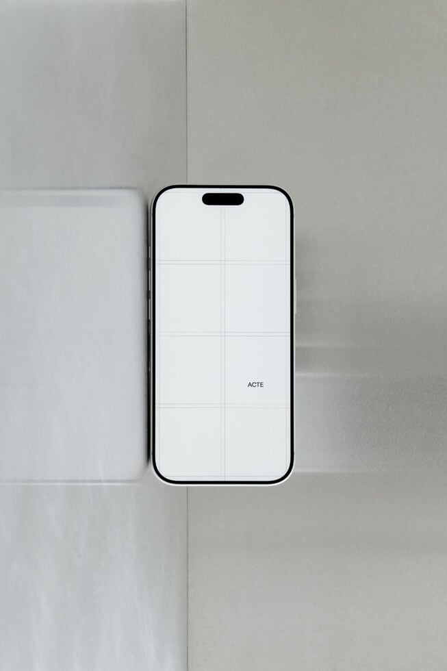 iPhone 14 Pro mockup with grid overlay on minimal neutral background