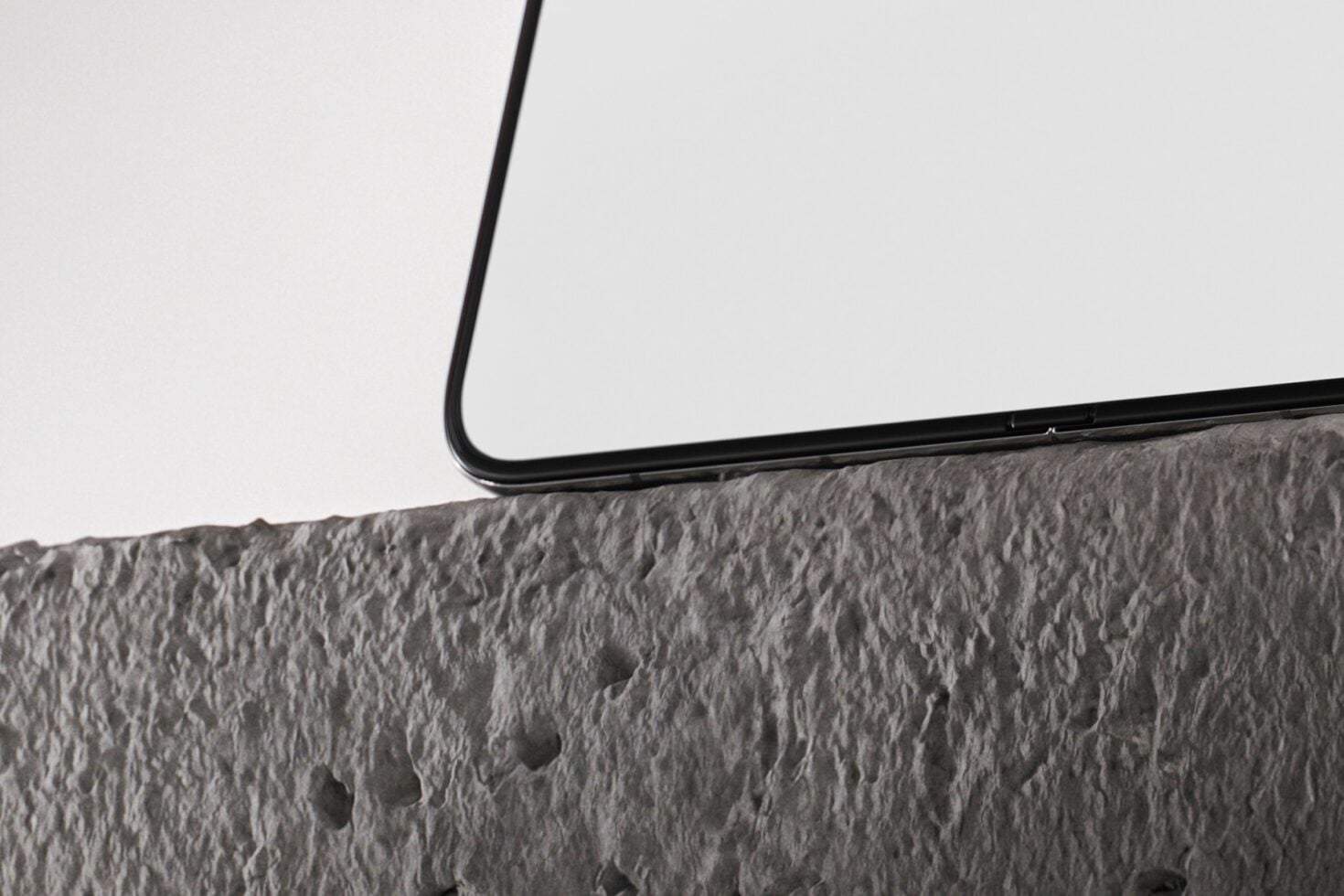 Smartphone resting on crumpled gray fabric with clean minimalist styling