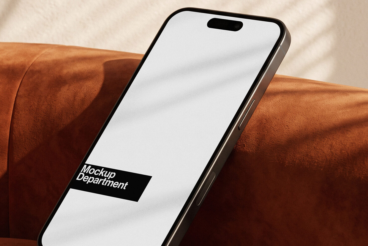 iPhone 14 Pro mockup lying on burnt orange leather with clean screen display