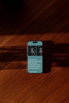 iPhone mockup displaying turquoise BMX gaming app with skateboard photos on wooden background