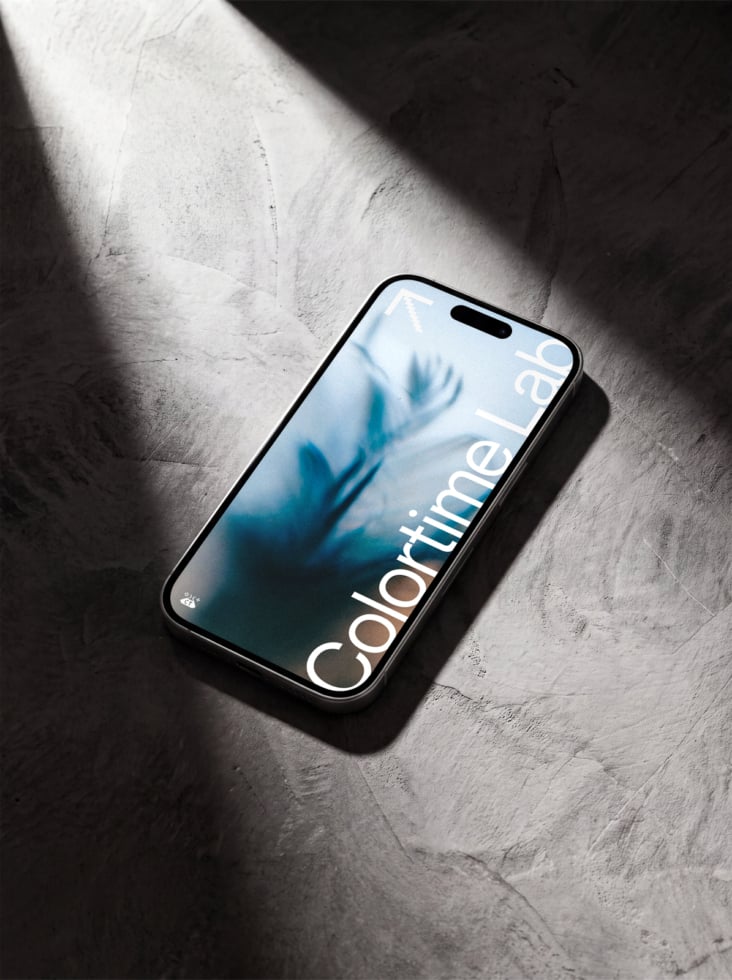 iPhone 14 Pro mockup with blue gradient display on concrete with dramatic sunlight
