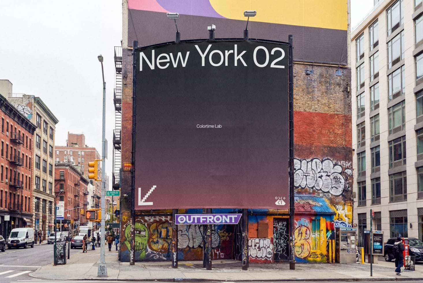 Large billboard mockup on NYC street with colorful overhead canopy, surrounded by brick buildings, graffiti, storefronts