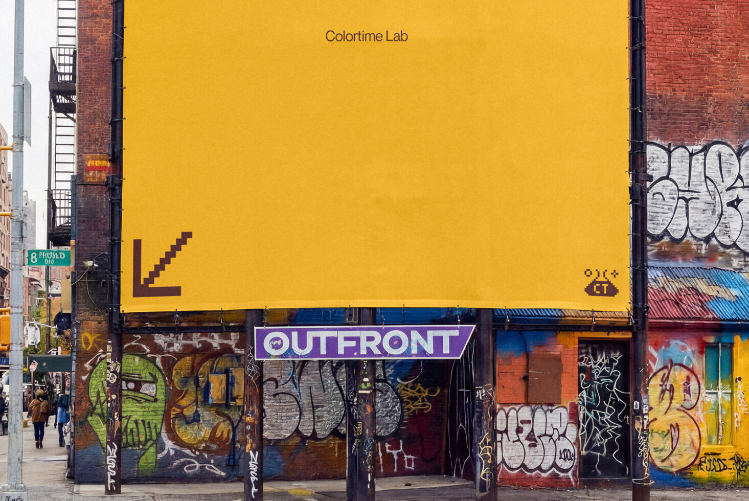 Bright yellow billboard with Colortime Lab branding above gritty street storefront covered in colorful graffiti tags