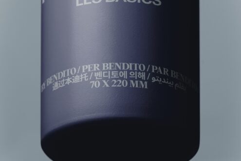Dark cylindrical bottle mockup with multilingual text embossed on curved surface showing dimensions
