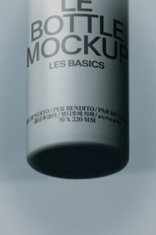 Cylindrical bottle mockup with multilingual label showing Les Basics branding on white background