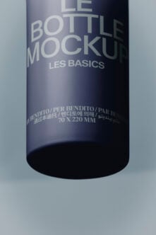 Sleek dark bottle mockup with multilingual label showing Les Basics branding