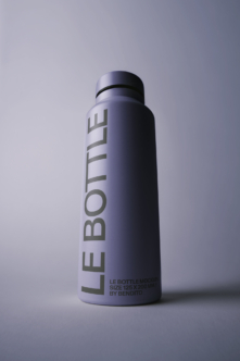 Sleek tall bottle mockup with vertical text wrap on lavender gradient background