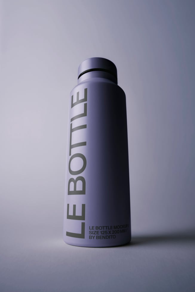 Sleek tall bottle mockup with vertical text wrap on lavender gradient background