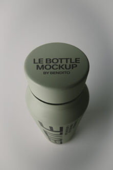 Sage green bottle mockup with screw cap showing label design on clean studio background