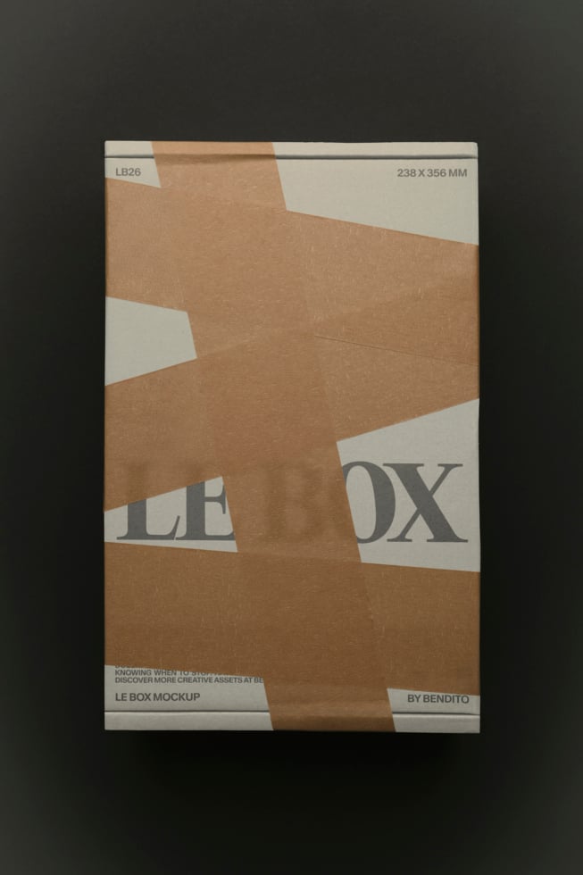 Kraft cardboard box mockup with white label strips, diagonal composition showing front view