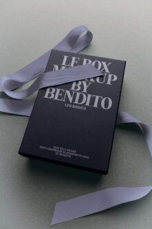 Luxury black box mockup with lavender ribbon tied around it, showing elegant serif typography for "Ledox" branding