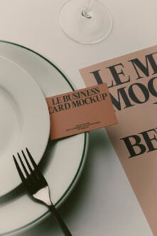 Business card mockup styled with plate, fork, wine glass on neutral background
