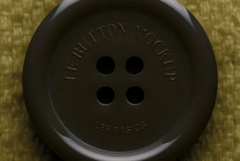 Oversized black button with embossed text on yellow textured background, product mockup