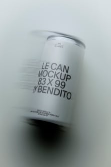 White aluminum can mockup with metallic rim, angled shot showing label wrap on soft gray background