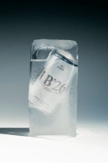 Frozen package with white label showing product details, frosted plastic wrap catching light