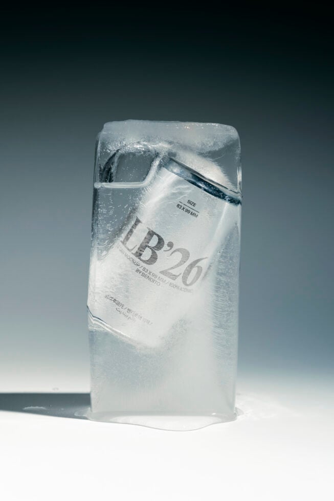 Frozen package with white label showing product details, frosted plastic wrap catching light