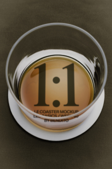 Glass coaster mockup showing 1.1 version number with white rim on olive background