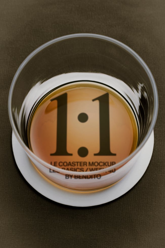 Glass coaster mockup showing 1.1 version number with white rim on olive background