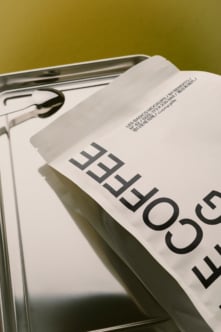 Magazine mockup with bold typography on olive backdrop, metal tray included
