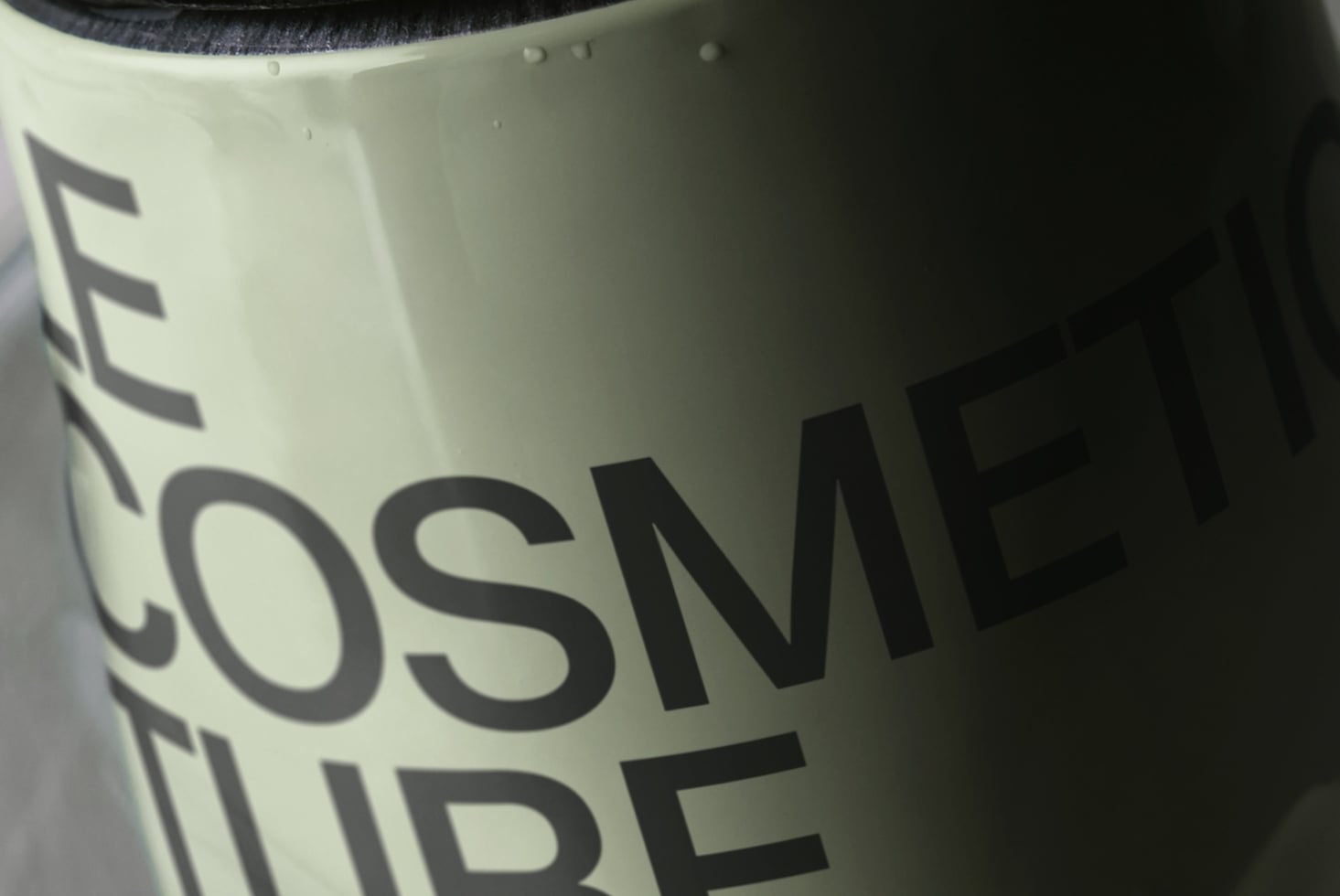 Close-up of cream ceramic mug with bold black typography printed on curved surface