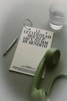 Letterhead mockup styled with vintage phone, pen, glass, neutral desktop setup