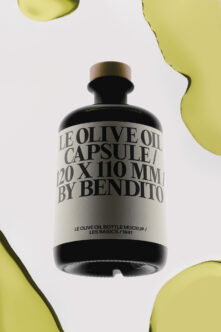 Sleek black olive oil bottle mockup with brass cap, surrounded by vibrant yellow-green organic shapes