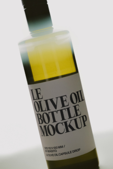Olive oil bottle mockup with brush applicator showing yellow liquid inside frosted glass container