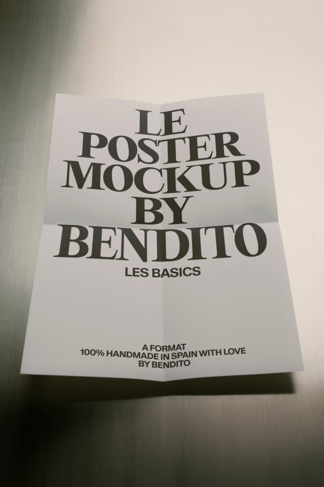 Folded poster mockup with serif typography displaying "Le Poster Mockup by Bendito" branding on textured background