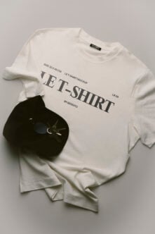 White tee mockup with black hat, watch, label tag showing specs by Bendito