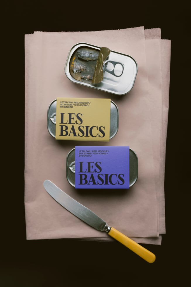 Tin can label mockup with yellow, blue labels on vintage metal cans, knife on paper