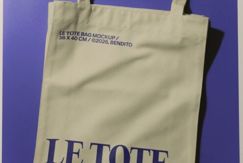 Cream canvas tote bag with navy text on vibrant purple background showing branding mockup