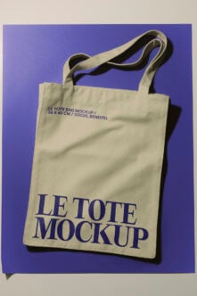Cream canvas tote bag mockup with navy text on purple background, 36x40cm