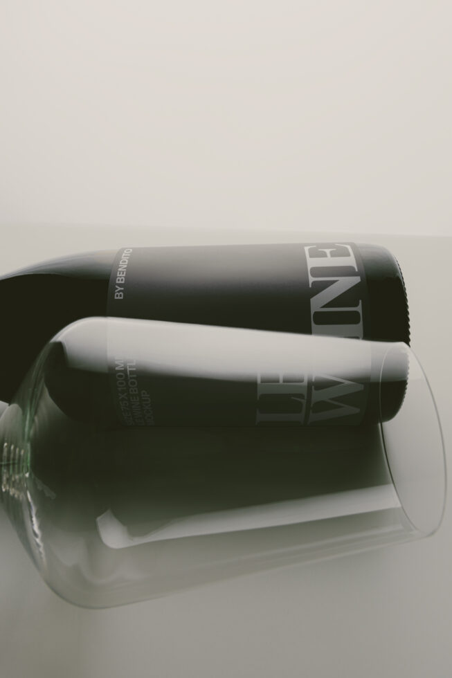 Two black cylinder cosmetic bottles stacked on minimal white background
