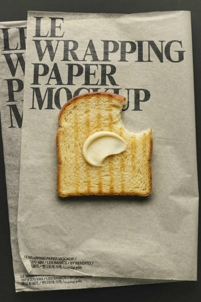 Kraft wrapping paper mockup with buttered toast on dark background
