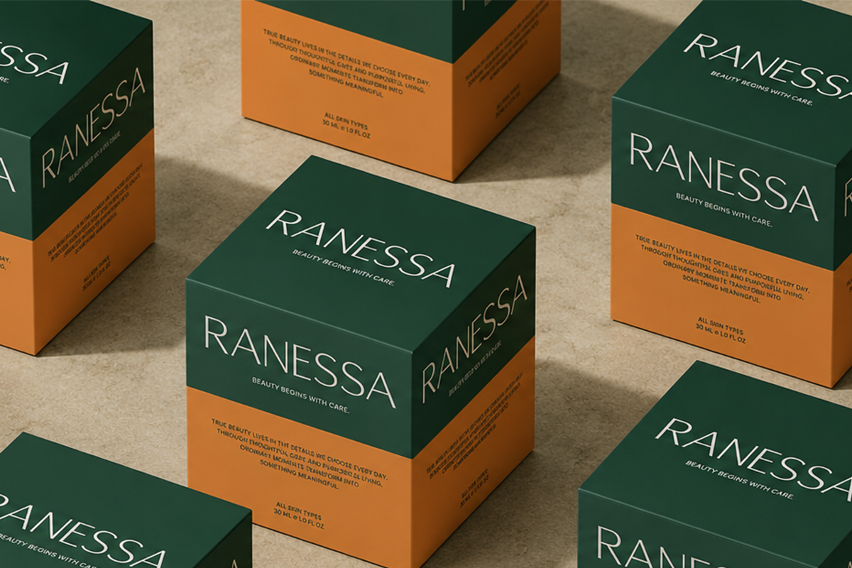 Luxury skincare boxes with deep green tops, warm orange bottoms, minimalist typography on concrete surface