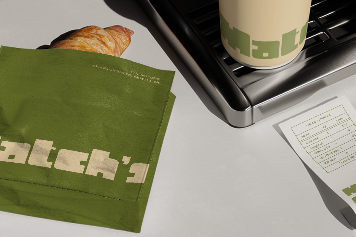 Flat lay of green cafe branding with croissant, coffee cup, business cards, notebooks