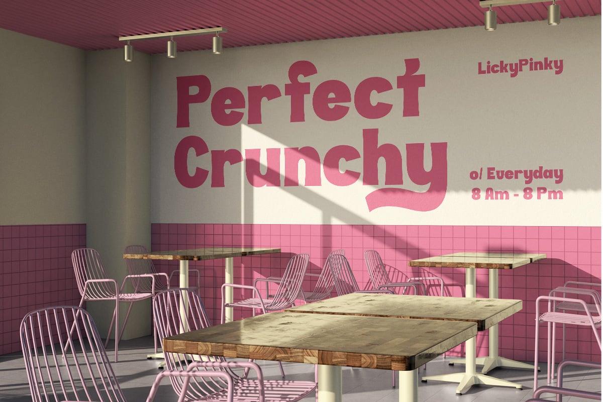 Modern cafe interior with pink wire chairs, wooden tables, magenta ceiling, brass lighting, tile wall details
