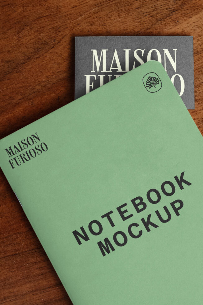 Mint green notebook with "Maison Furioso" branding stacked on wooden surface with matching card