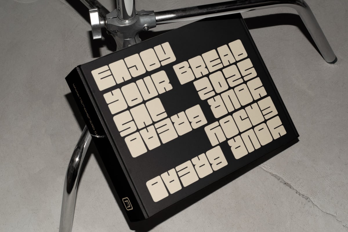 Tablet mockup with motivational text in bold cream letters on black screen, clamped to metal stand