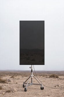 Mobile billboard mockup standing in desert landscape with tripod wheels
