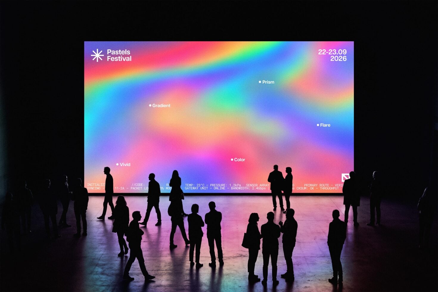 Colorful gradient screen display with silhouettes of people standing in front during Pastels Festival event