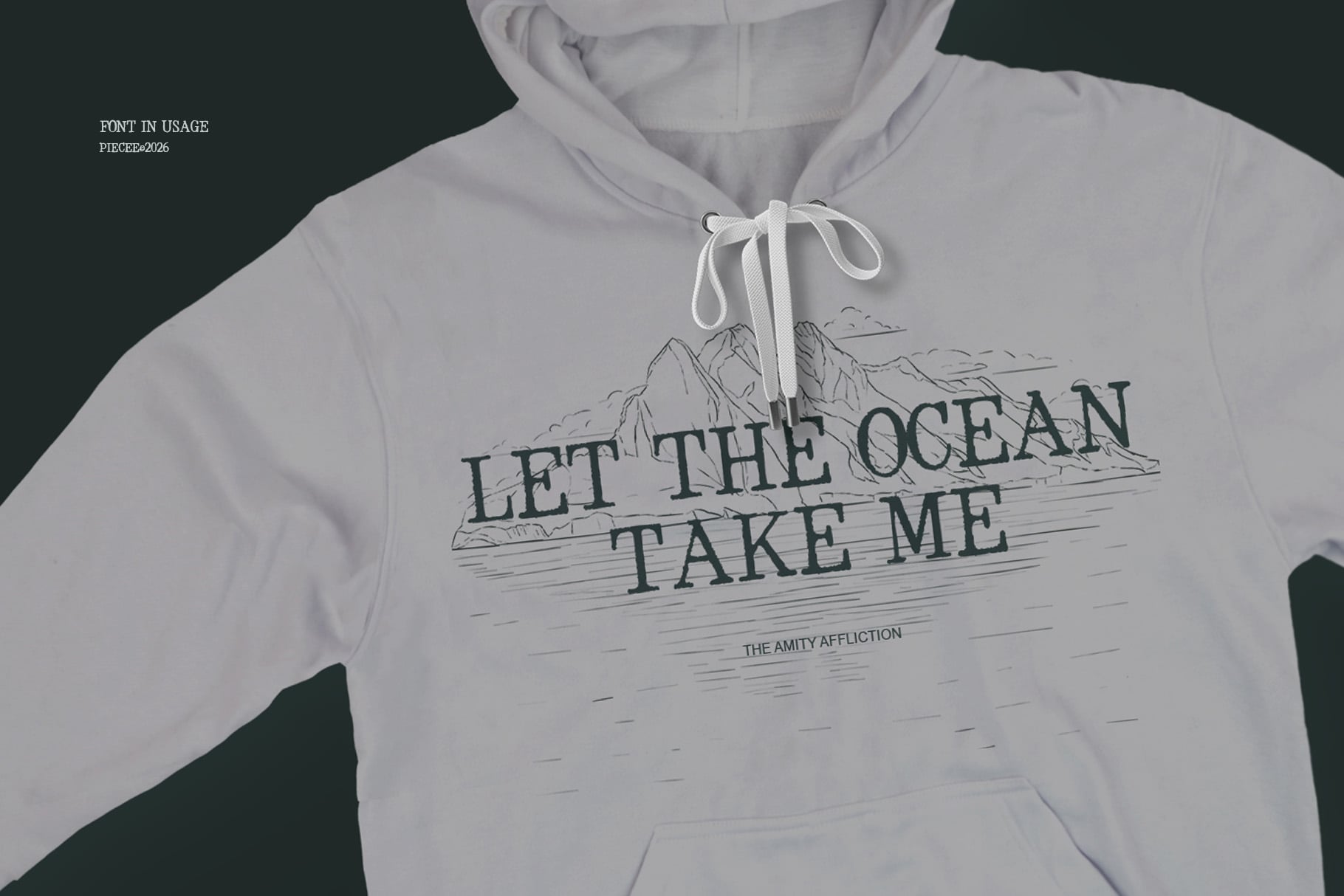 White hoodie mockup with ocean landscape sketch design, text reads Let The Ocean Take Me