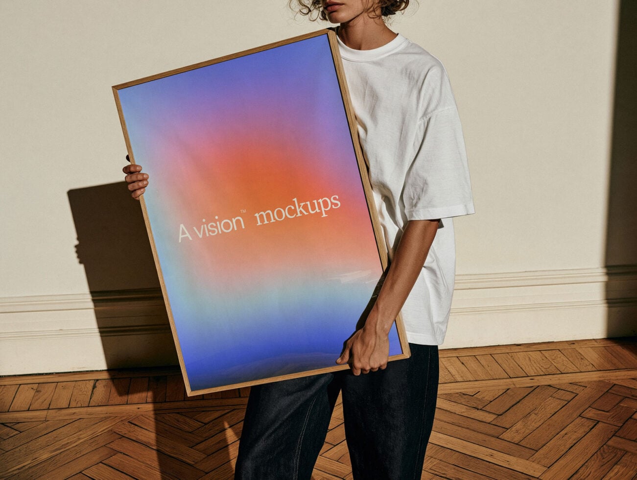 Person holding wooden framed poster with gradient design in bright interior space