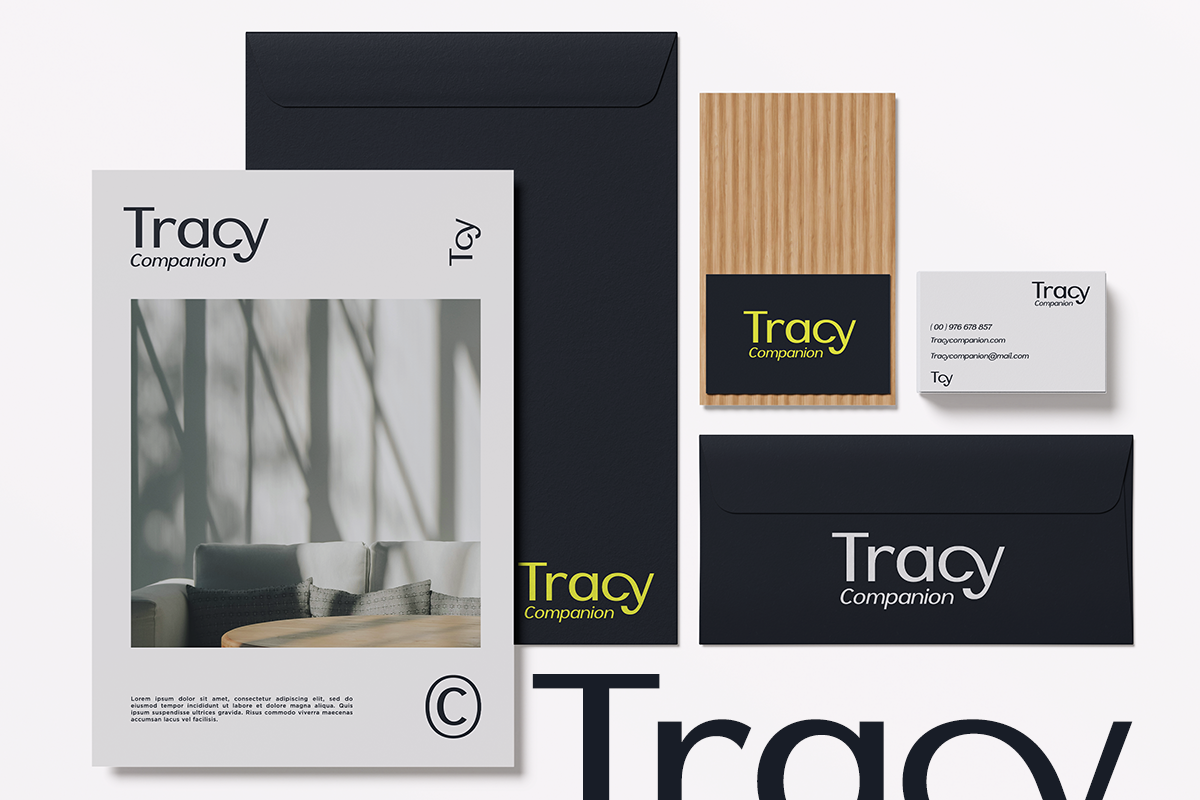 Tracy Companion brand identity mockup with business cards, envelopes, letterhead in black, natural wood tones
