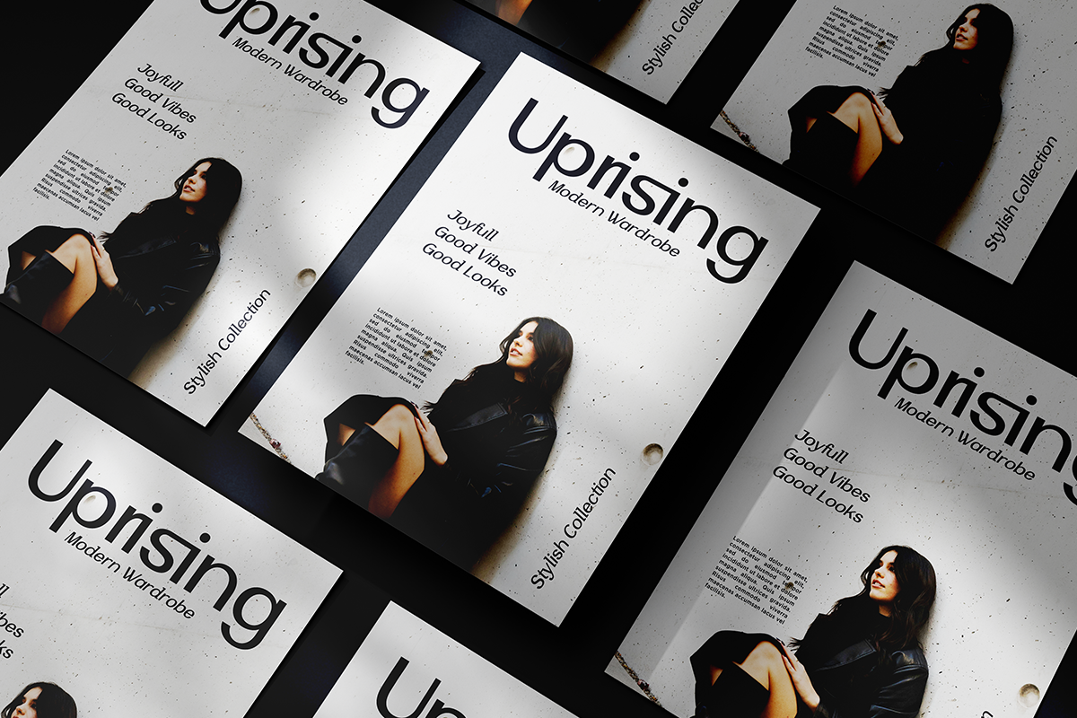 Overhead shot of modern fashion magazine mockups with black leather styling, model photos, typography layouts arranged in diagonal pattern